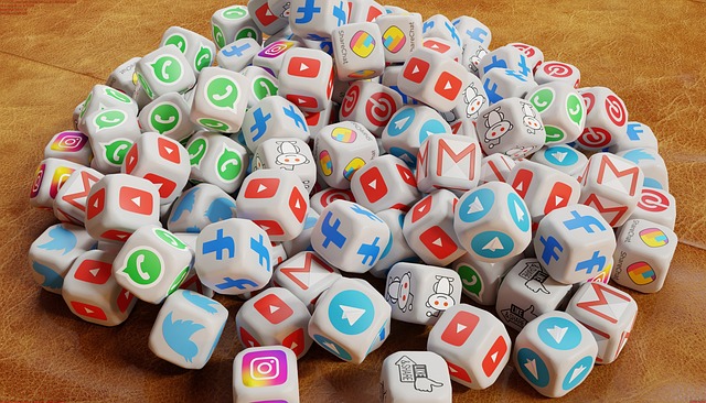 A pile of dice, each featuring logos of popular social media platforms and messaging apps.