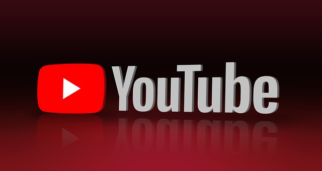 
The YouTube logo with a red play button icon and reflective text on a dark gradient background.