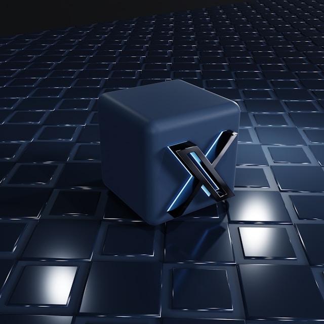 A futuristic, metallic cube with an "X" symbol on its side, set on a reflective, tiled surface in a dark, sleek environment.